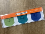 Of 3 Le Creuset Caribbean Palm & Cobalt Blue 4" Silicone Knob Storage Lids. Fixed Price $45.99.