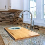 Over The Sink Bamboo Cutting Board W/ Collapsible Strainer & Phone Stand. Fixed Price $39.95.