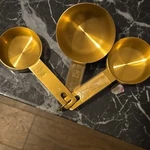 Williams Sonoma Three Gold Measuring Cups, Retail Price $49.95. Fixed Price $45.00.
