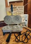 Dolce Automatic Electric Pizzelle Baker Maker Model 300-EP Box, Manual Excellent. Fixed Price $130.00.