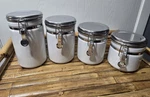 Anchor Hocking 4-PIECE Ceramic Canister Set With Clamp Top Lid, Good Condition. Fixed Price $22.00.
