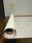White Peel And Stick Wallpaper With Grid Lines To Assist Cutting. Fixed Price $20.00.